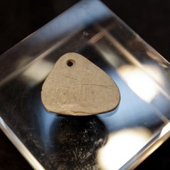 The 11,000 year old engraved shale pendant discovered by archaeologists during excavations at the Early Mesolithic site at Star Carr in North Yorkshire. Image taken at the Yorkshire Museum, York © Suzy Harrison